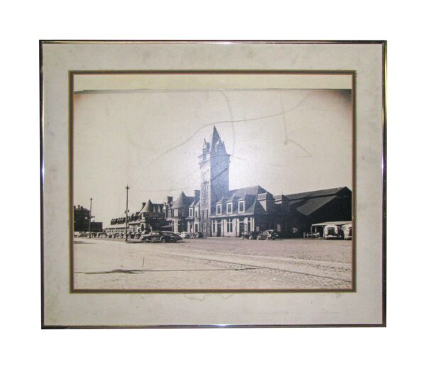 Framed black and white train station photograph with a wide matte and thin outer frame.