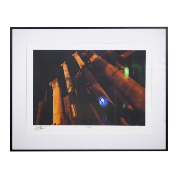 Framed architectural photograph of Gothic columns, shown in a steel frame with wide matting and a visible artist signature along the bottom edge.