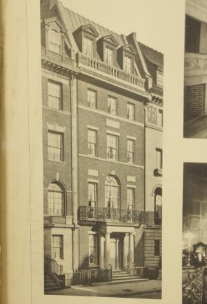 Framed photograph of a New York City residence, showing a tall brick façade with dormer windows, a balcony, and an arched entrance.