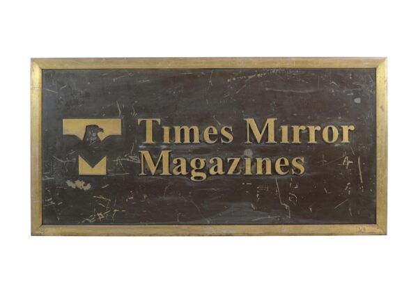 Rectangular bronze plaque with an antique finish, engraved with the Times Mirror Magazines logo and text, shown front on with visible surface scratches on the brown painted panel.