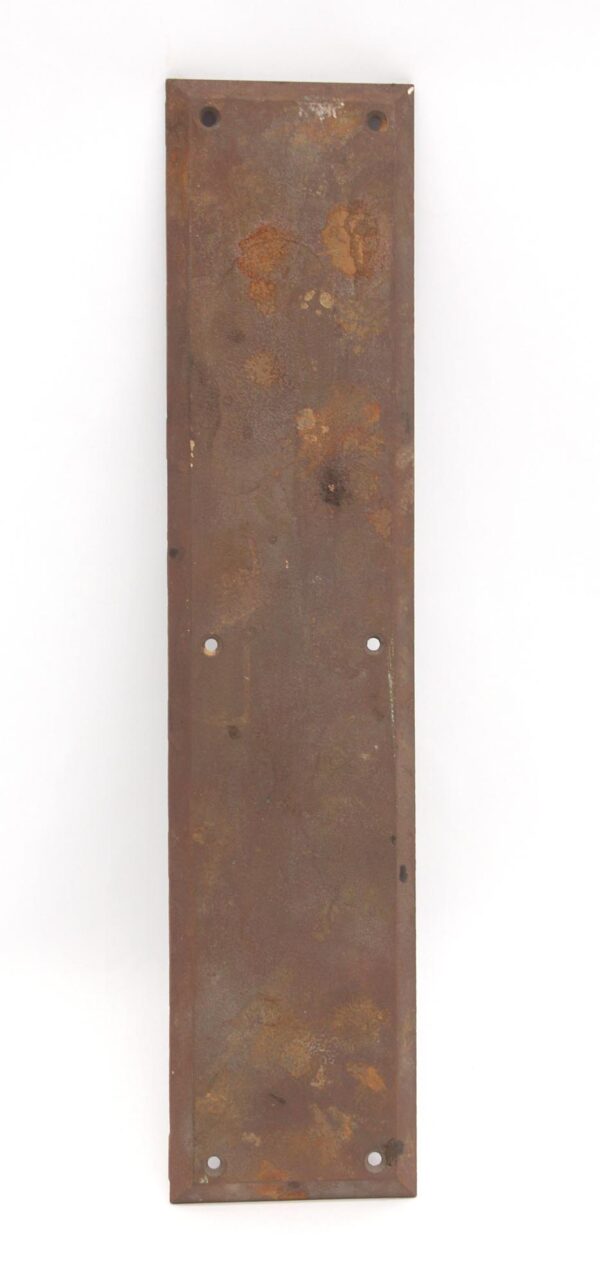 Vertical cast iron door push plate with beveled edges and four mounting holes, shown in a straight-on view with a worn surface.