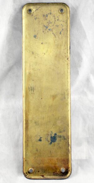 Vintage brass door push plate with four screw holes and visible age wear.