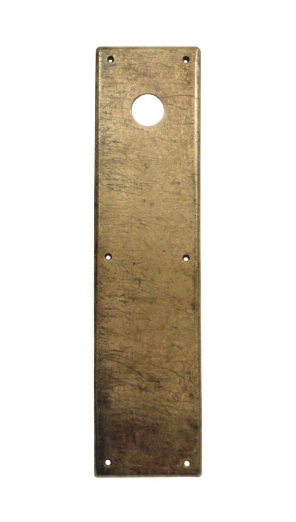 Vintage brass door push plate with a lock cutout and screw holes.
