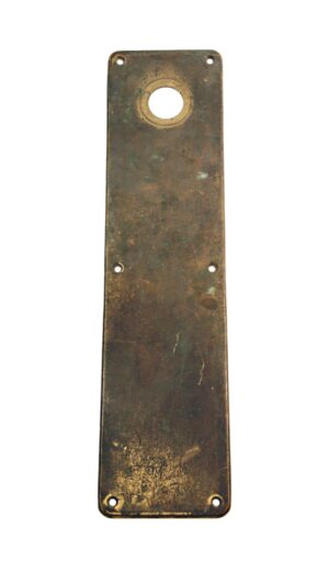 Antique brass door push plate with a round lock insert and four screw holes, shown upright.