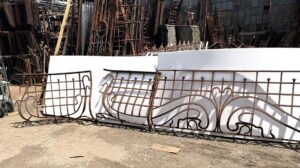 Art Nouveau wrought iron balcony railing with a central curved section and matching extensions shown front-on.