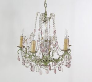 Five-arm chandelier with a muted green frame, clear and amethyst crystal bead chains, teardrop pendants, and candle-style sockets.