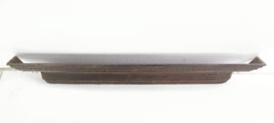 Carved mahogany door header with egg and dart detail and a long, narrow profile shown straight on.