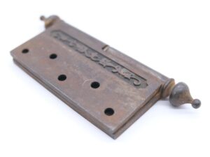 Victorian cast iron butt door hinge with steeple tips, a staggered hole pattern, and two knuckles shown at an angle.