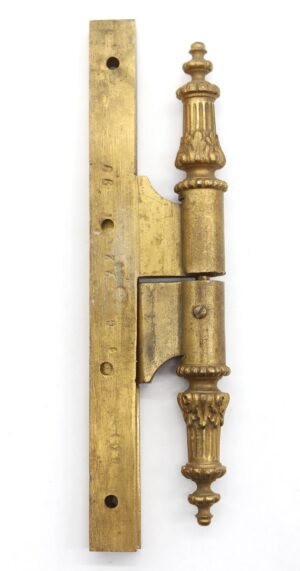 Antique bronze door hinge with ornate steeple tip, shown in a side view with the mounting plate and two knuckles visible.