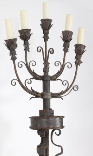 Wrought iron candelabra floor lamp with five candle-style lights, curled arms, and foliate details.