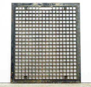 Reclaimed cast iron wall grate with a square grid pattern and surface rust, shown front on.
