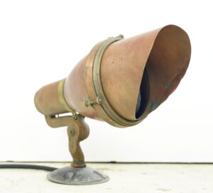 Vintage mountable spotlight with a blue lens, copper housing, and brass trim shown in side view.