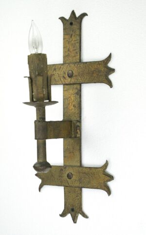 Spanish Revival wall sconce with one arm, showing an antique bronze finish and decorative cutout details with a single bulb socket.