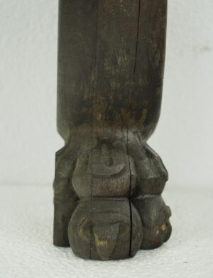 Close-up of a pine snake furniture carving showing the carved foot and lower body in dark wood tone.