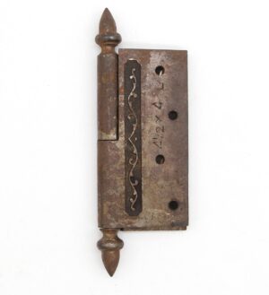 Victorian cast iron lift-off butt door hinge with acorn tips and a staggered hole pattern, shown in close-up.