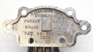 Vintage brass ice box hinge with a chrome finish, shown in close-up with the makers stamped plate and mounting holes visible.