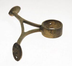 Vintage brass banister bracket with three mounting plates and a circular rail holder.