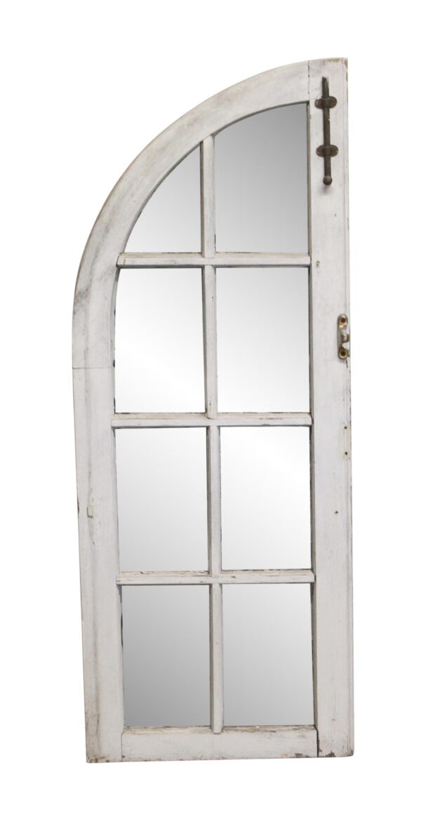 Arched wood frame window with eight panes, shown with a white side and one missing pane.