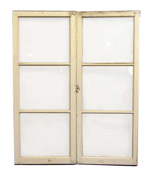 Pair of wood-framed windows with three panes each, shown closed with clear glass and a painted finish.