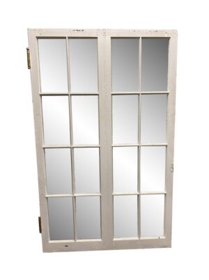Wide white wooden French window with 16 glass panes and visible hinges, shown closed.