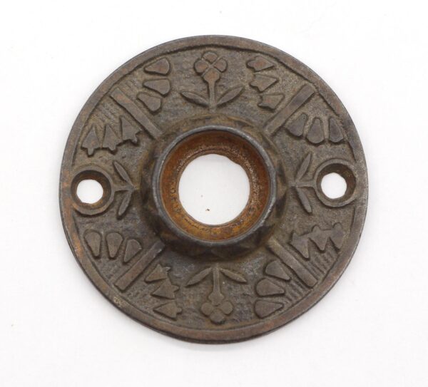 Ornate cast iron door rosette with a central opening and two screw holes, shown from the front with floral Aesthetic patterning.