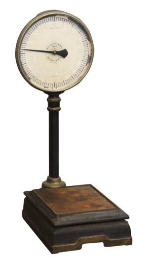 Turn-of-the-century lollipop scale with a round dial, slender post, and cast iron base, shown in black finish.