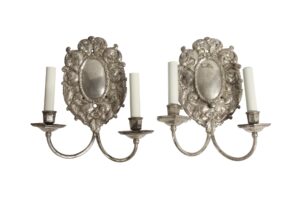 Pair of silvered brass two-arm wall sconces with ornate Louis XV Rococo floral and foliage detailing.