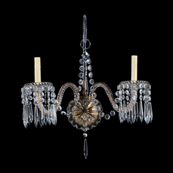 1920s bronze and clear crystal two-arm sconce with hanging crystal pendants and two candle-style bulb holders.