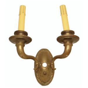 Empire-style two-arm wall sconce with an antique bronze finish and two upward candle holders.