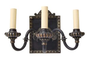Pair of Tudor-style metal wall sconces with black and gold finish, each with two curved arms and three candle sleeves around a decorative backplate.