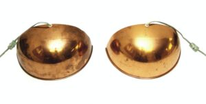 Pair of copper-plated dome wall sconces shown side by side, each with a cord and the opening for upward light.