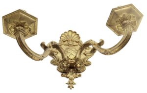 Pair of antique brass two-arm wall sconces with ornate French detailing and hexagonal backplates, shown as a matching pair.
