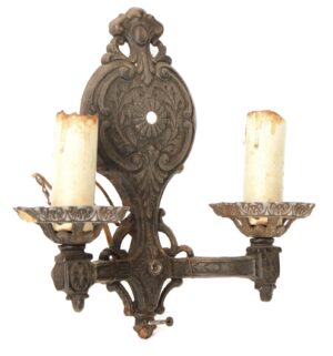 Antique Victorian two-arm ornate wall sconce with cast metal construction, black finish, and two candle-style holders.