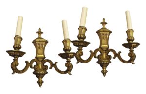 Pair of Empire-style wall sconces with gilt bronze arms and candle-style sockets, shown as a matching pair.