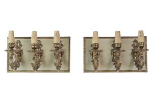 Pair of French-style wall sconces with three brass candlestick arms on each rectangular backplate, shown side by side as a pair.