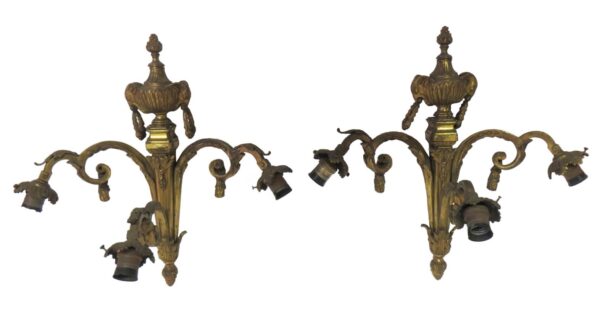 Pair of French cast bronze wall sconces with three curved arms each, decorative details, and a matching antique bronze finish.