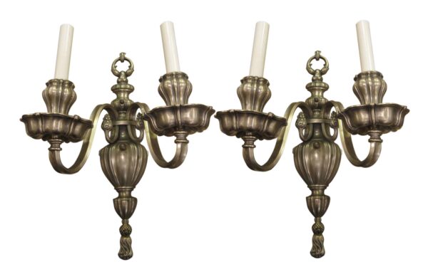 Pair of Georgian style two-arm wall sconces with silver finish and candle-style holders.