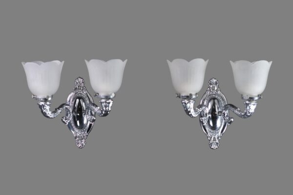 Pair of Victorian wall sconces with two glass shades and polished nickel arms, shown front on.