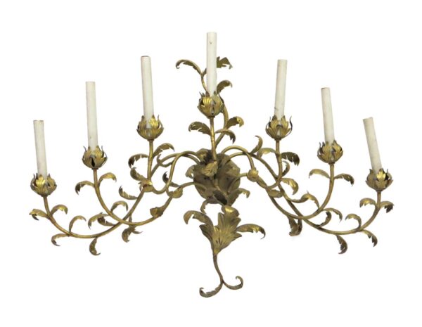Ornate seven-arm wall sconce with curved metal arms and candle-style holders in a gold finish.