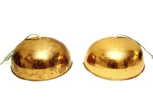 Pair of dome wall sconces with a copper finish and attached cords, shown side by side in a front view.