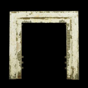 Victorian white cast iron fireplace insert surround with worn paint and a rectangular opening.