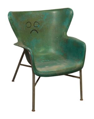 Multicolored fiberglass chair with a molded seat and back, shown in three-quarter view with steel legs and visible wear on the seat and legs.