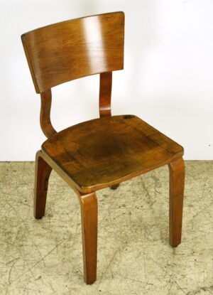 Mid century modern chair with a curved backrest, bentwood legs, and a dark wood tone finish.