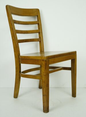 Wood slatted chair with a tall back and medium wood tone shown in three-quarter view.