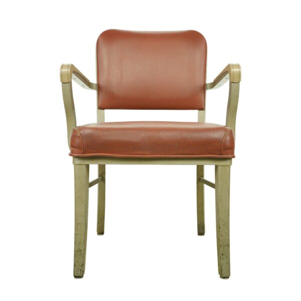 Front view of a vintage arm chair with a red seat and back, tan steel frame, and curved arms.