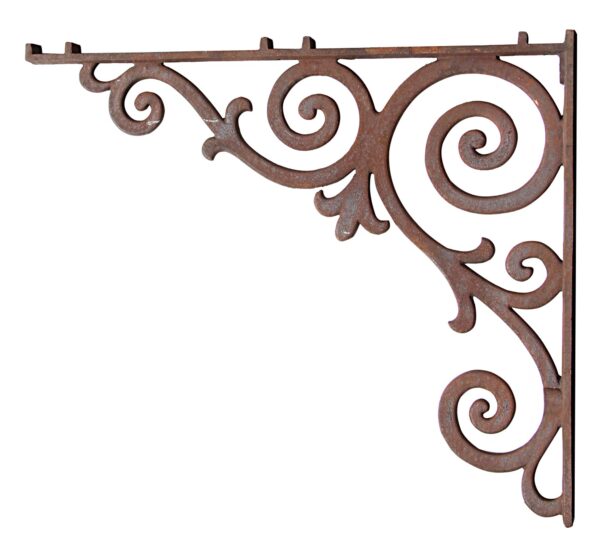 Cast iron bracket with ornate scrollwork and a broken top section.