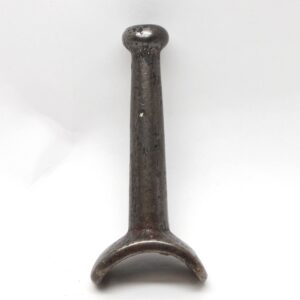 Vintage cast iron wardrobe hook with a rounded back and single upright peg.