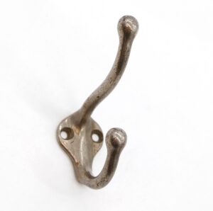 Vintage double-arm wall hook with two mounting holes and a worn nickel finish.