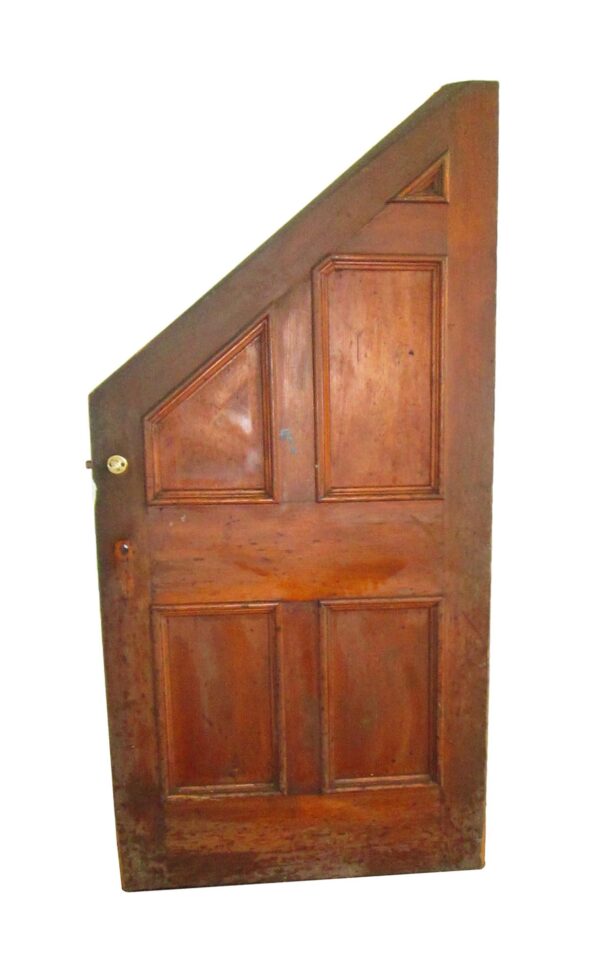 Wooden slanted privacy door with five panels, shown at an angle, with a cracked piece of molding near the bottom.