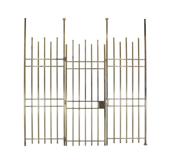 Mid-century brass vault gate set with two fixed side sections and a hinged center door, shown frontally with tall vertical bars and a visible latch on the right side.